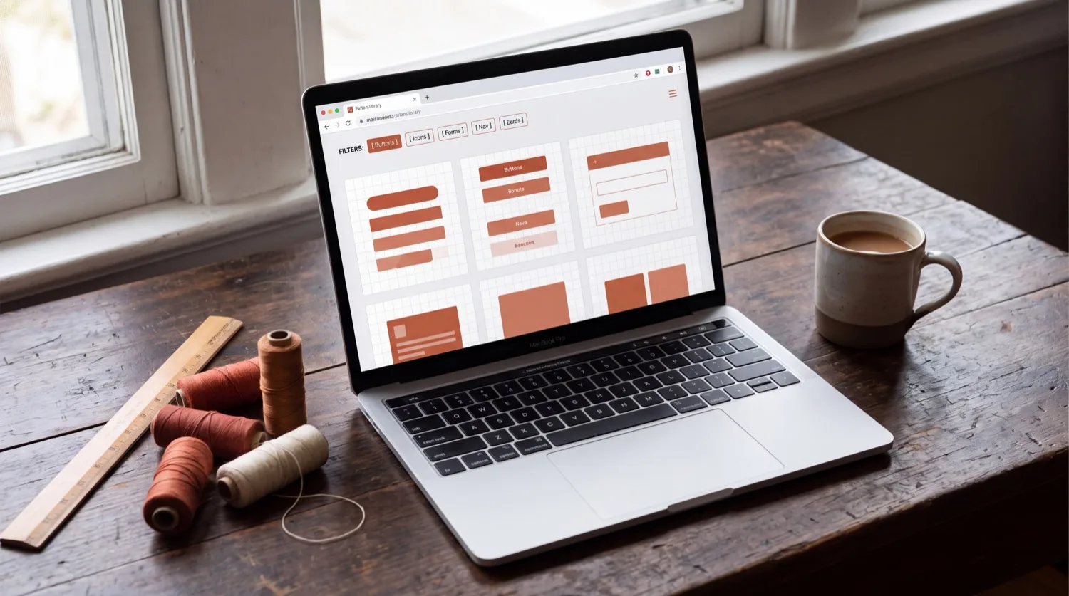 THE CRAFT SEQUENCE — the STITCH & PIN™ app open on a laptop, showing the design library with filters